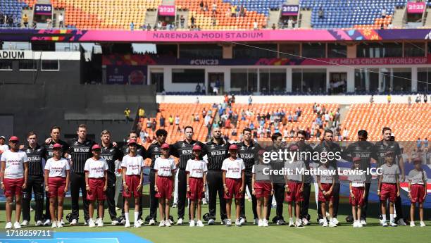 Players of New Zealand line up for the National Anthems ahead of the ICC Men's Cricket World Cup India 2023 between England and New Zealand at...