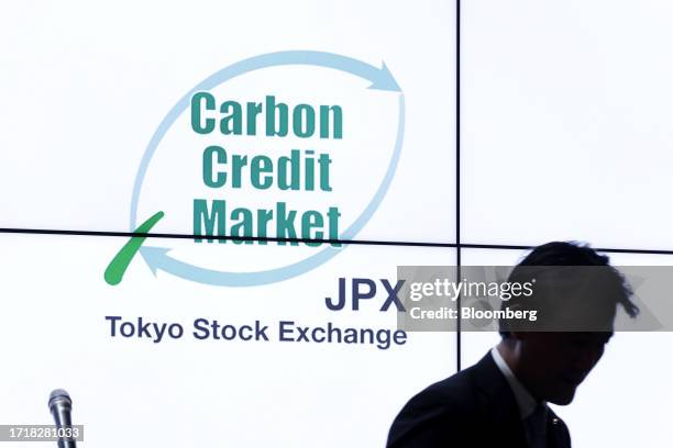 Signage displayed on a screen during a ceremony marking the opening of the carbon credit market at the Tokyo Stock Exchange , operated by Japan...