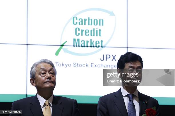 Hiromi Yamaji, chief executive officer of Japan Exchange Group Inc. , left, and Yasutoshi Nishimura, Japan's trade minister, attend a ceremony...