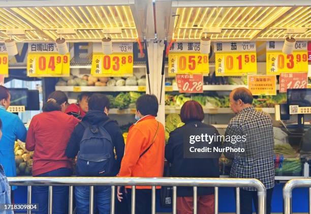 People buy vegetables at a ''bus convenience station'' in Beijing, China, October 11, 2023. Recently, the ''bus convenience station'' converted from...