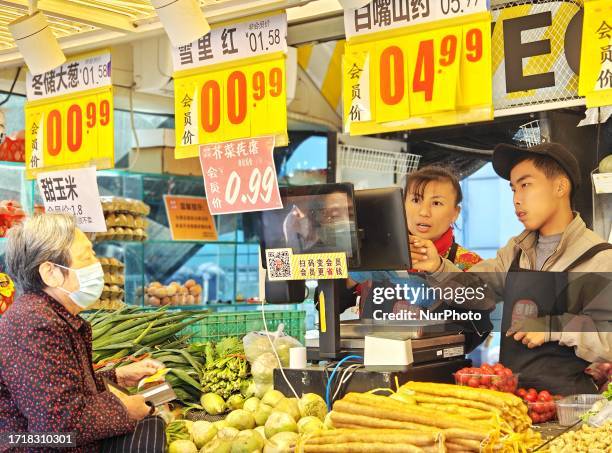 People buy vegetables at a ''bus convenience station'' in Beijing, China, October 11, 2023. Recently, the ''bus convenience station'' converted from...