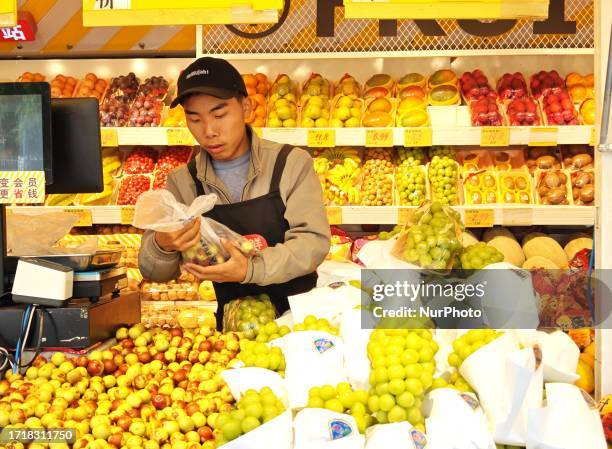 People buy vegetables at a ''bus convenience station'' in Beijing, China, October 11, 2023. Recently, the ''bus convenience station'' converted from...