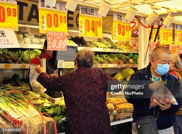 People buy vegetables at a ''bus convenience station'' in Beijing, China, October 11, 2023. Recently, the ''bus convenience station'' converted from...