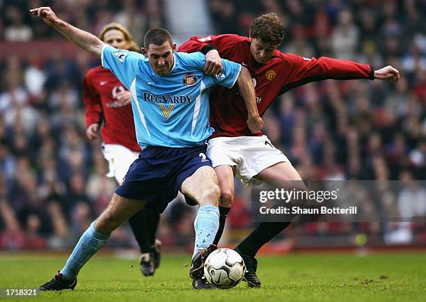 Stephen Wright of Sunderland tussles with Ole Gunnar Solskjaer of Manchester United for the ball during the FA Barclaycard Premiership match between...