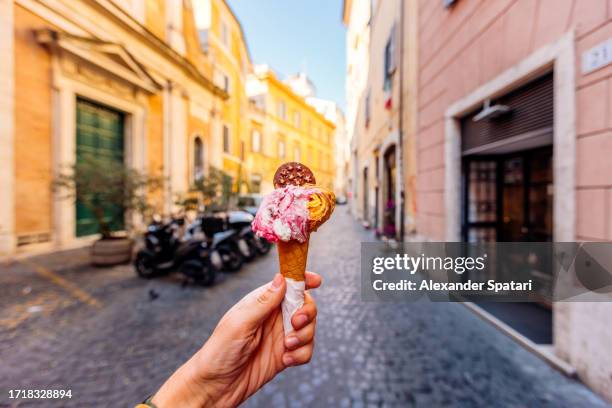 eating gelato ice cream on the streets of rome, personal perspective point of view (pov) - gelato stock-fotos und bilder