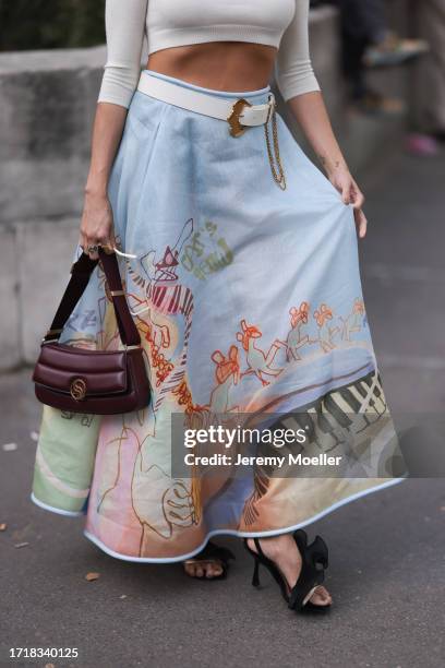 Ashley Park is seen outside Zimmermann show wearing golden sunnies with orange shades, crystal beige headband, white turtle neck cropped top with...