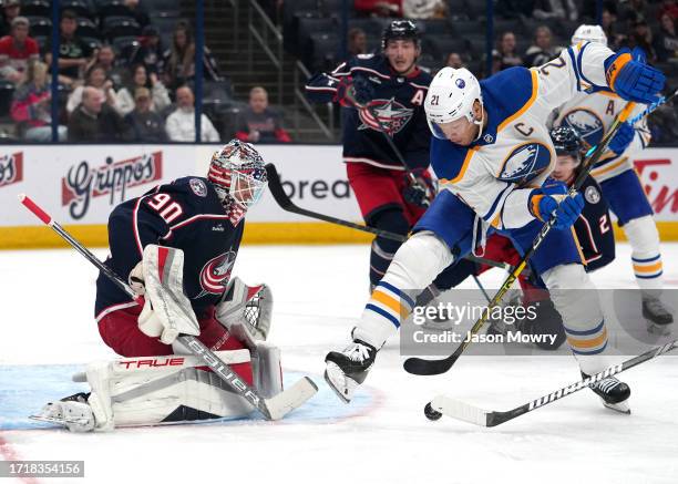 Kyle Okposo of the Buffalo Sabres controls the puck in front of Elvis Merzlikins of the Columbus Blue Jackets during the first period in a preseason...