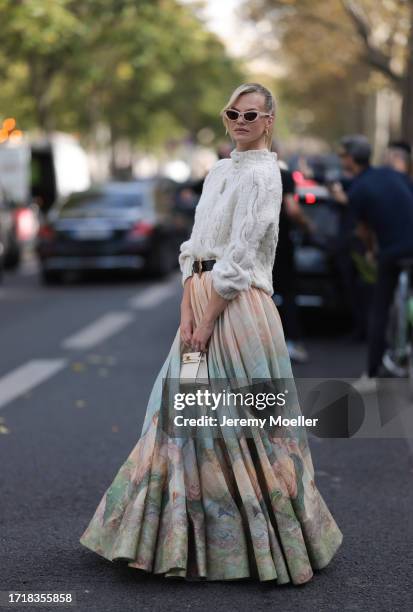 Nadine Leopold is seen outside Zimmermann show wearing pink glasses, heavy knit sweater in white, black Zimmermann belt with golden hardware, long...