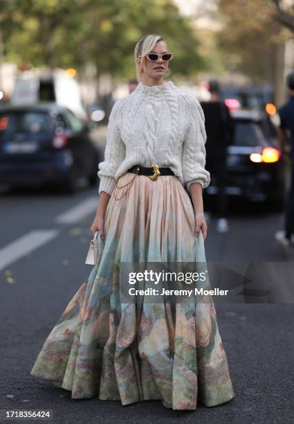 Nadine Leopold is seen outside Zimmermann show wearing pink glasses, heavy knit sweater in white, black Zimmermann belt with golden hardware, long...