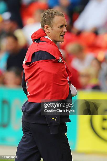 Brent Reilly of the Crows on the sideline after being injured during the round 14 AFL match between the Gold Coast Suns and the Adelaide Crows at...