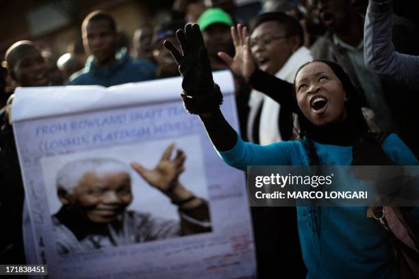 Woman dances with other residents of the strike prone mining region of Marikana in South Africa outside the Mediclinic Heart Hospital where former...