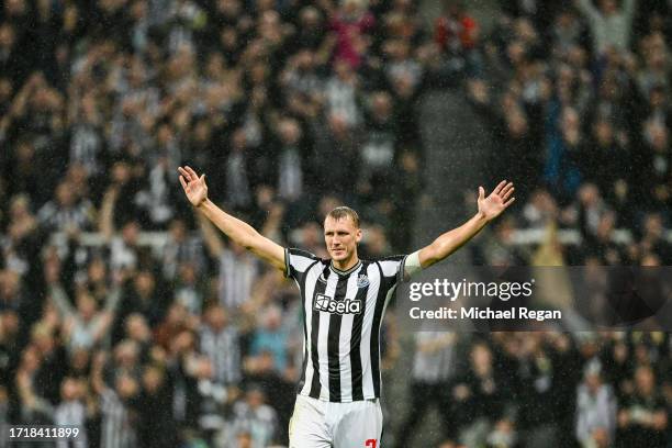 Dan Burn of Newcastle United celebrates after scoring the team's second goal during the UEFA Champions League match between Newcastle United FC and...