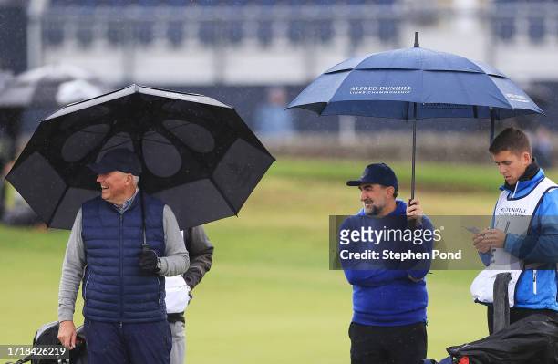 Martin Slumbers, Chief Executive of the R&A and LIV Golf Chairman, Yasir al-Rumayyan interact on the first green during Day One of the Alfred Dunhill...