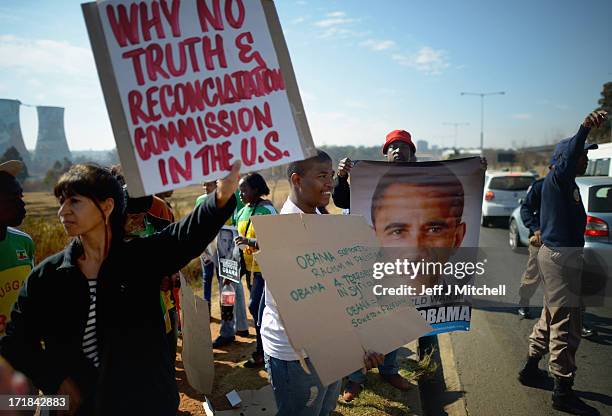 Protesters gather outside Johannesburg University in Soweto in advance of President Obama'smeeting with students later today on June 29, 2013 in...