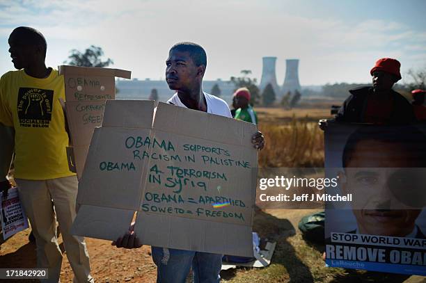 Protesters gather outside Johannesburg University in Soweto in advance of President Obama'smeeting with students later today on June 29, 2013 in...