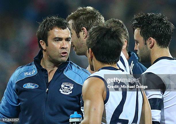 Cats coach Chris Scott speaks to Mathew Stokes during the round 14 AFL match between the Geelong Cats and the Fremantle Dockers at Simonds Stadium on...