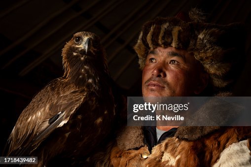 Portrait of a Mongolian eagle hunter, with his Golden eagle