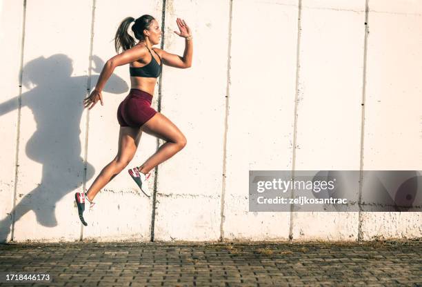 mujer joven ejercer fuera de - running shorts fotografías e imágenes de stock