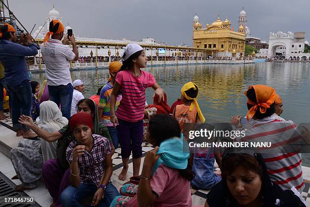 Indian Sikh devotees pay their respects at the Sikh Shrine, The Golden Temple in Amritsar on June 29,2013. On the occasion of the 174th death...