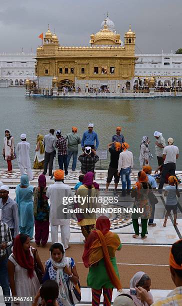 Indian Sikh devotees pay their respects at the Sikh Shrine, The Golden Temple in Amritsar on June 29,2013. On the occasion of the 174th death...