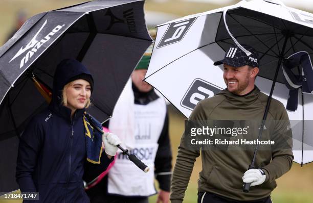Actress, Kathryn Newton interacts with Connor Syme of Scotland on the sixth hole during Day One of the Alfred Dunhill Links Championship at...