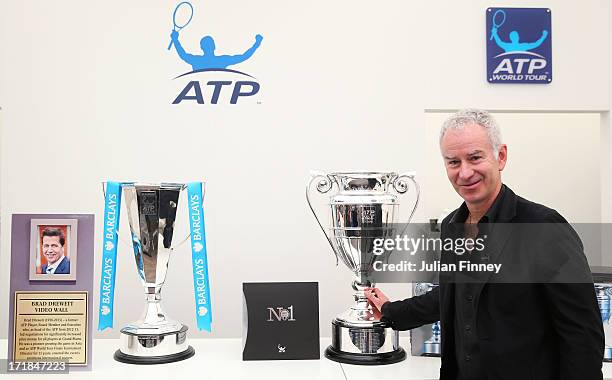 Former World Number 1 John McEnroe poses with the newly-named Brad Drewett Trophy , presented to the winner of the ATP World Tour Finals, and the ATP...