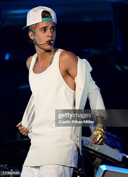 Recording artist Justin Bieber takes off his jacket as he performs during his Believe Tour at the MGM Grand Garden Arena on June 28, 2013 in Las...