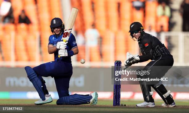 Joe Root of England plays a shot as Tom Latham of New Zealand keeps during the ICC Men's Cricket World Cup India 2023 between England and New Zealand...