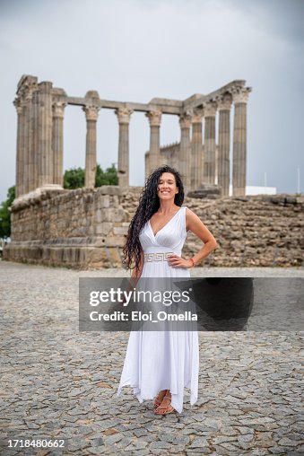 happy woman visiting Roman Temple of Diana in Evora, Portugal