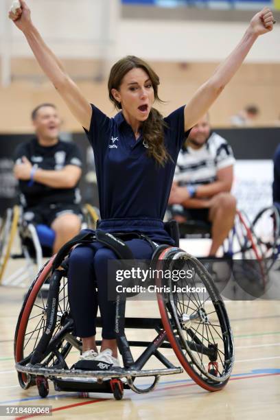 Catherine, Princess of Wales celebrates during her wheelchair rugby training session facilitated by members of the world-cup winning England...