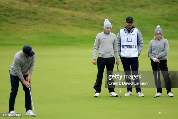 Matthew Fitzpatrick of England and his playing partner his mother Susan Fitzpatrick watch Alex Fitzpatrick putt on the sixth hole during the first...