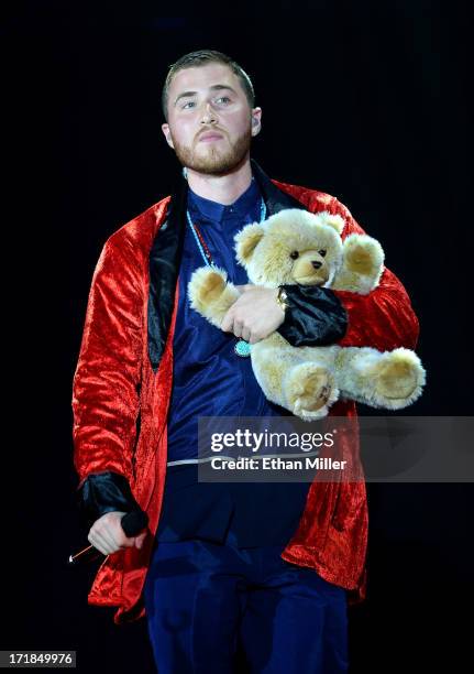 Recording artist Mike Posner holds a stuffed bear as he performs while opening for Justin Bieber at the MGM Grand Garden Arena on June 28, 2013 in...