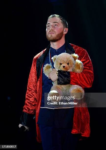 Recording artist Mike Posner holds a stuffed bear as he performs while opening for Justin Bieber at the MGM Grand Garden Arena on June 28, 2013 in...