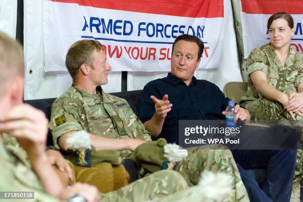 British Prime Minister David Cameron speaks with troops during a visit to Camp Bastion on June 29, 2013 near Lashkar Gah, in the southern Helmand...