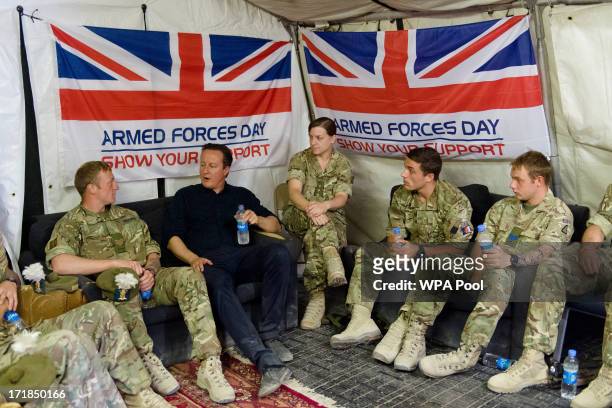 British Prime Minister David Cameron speaks with troops during a visit to Camp Bastion on June 29, 2013 near Lashkar Gah, in the southern Helmand...