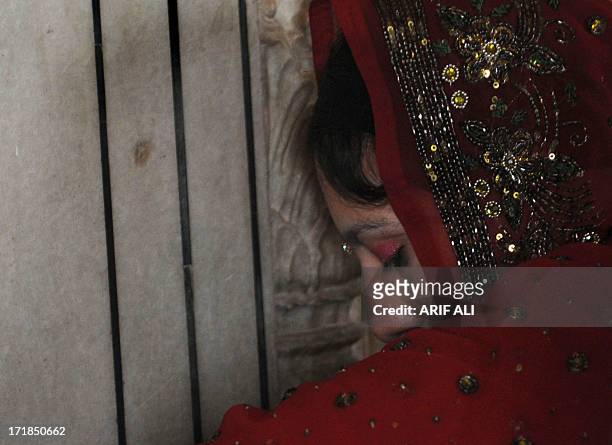 Devotee prays at a Sikh shrine in Lahore on June 29 on the 174th death anniversary of Maharaja Ranjit Singh. Singh was also known as 'Sher-e-Punjab'...