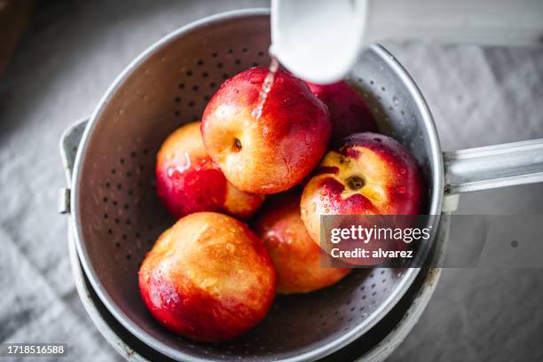 rinsing apples in colander - apple water splashing stock pictures, royalty-free photos & images