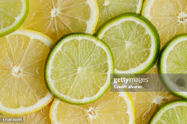 citrus fruit of lime slices background - sour taste stock pictures, royalty-free photos & images