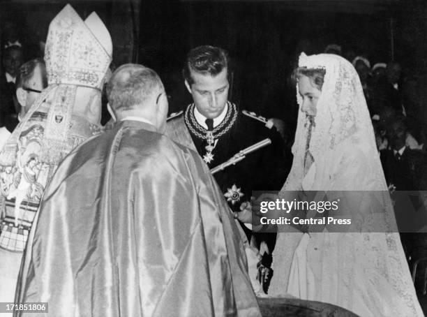 Prince Albert of Belgium, later King Albert II of Belgium and Princess Paola of Belgium exchange rings at their wedding ceremony being held in the...