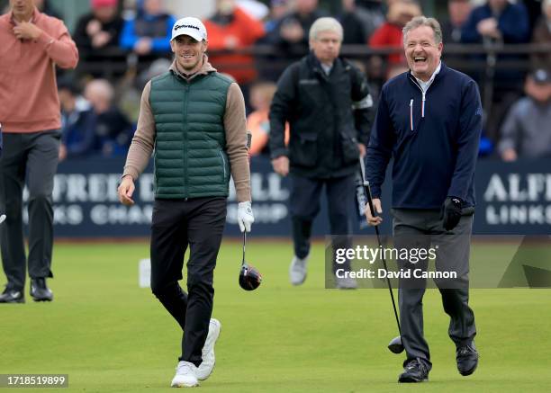 Gareth Bale of Wales the former international soccer player walks off the first tee with Piers Morgan the media personality during the first round of...