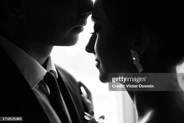 young peaceful bride close to the elegant groom - married silhouette stock pictures, royalty-free photos & images