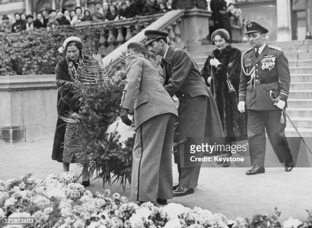 Princess Josephine-Charlotte of Belgium and Grand Duke Jean of Luxembourg , seen for the first time since their engagement, place a wreath at the...
