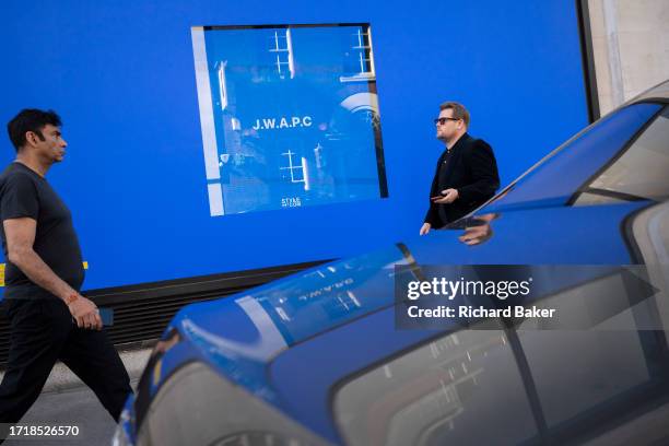 Shoppers walk past a window of Sefridges, on 10th October 2023, in London, England.