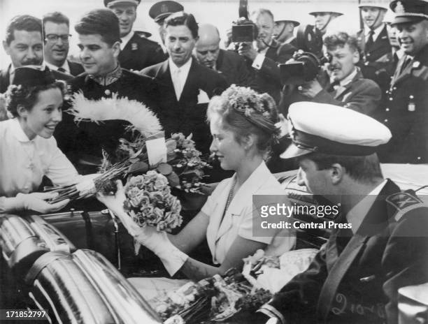 Princess Paola of Belgium and Prince Albert of Belgium, later King Albert II of Belgium meet crowds gathered outside Brussels Town Hall whilst...