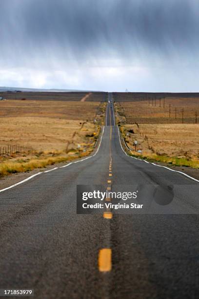 raining on route 64 new mexico usa - ship rock stock pictures, royalty-free photos & images