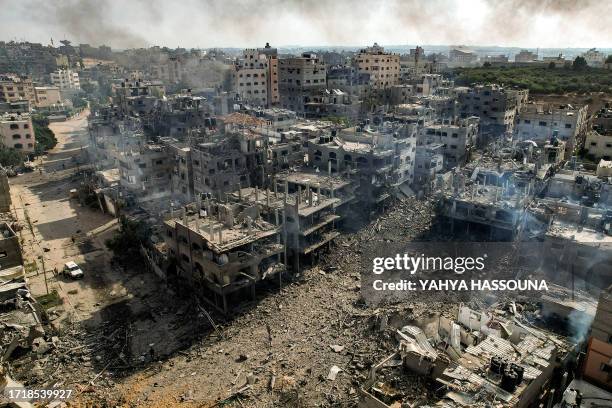 This picture taken on October 11, 2023 shows an aerial view of buildings destroyed by Israeli air strikes in the Jabalia camp for Palestinian...