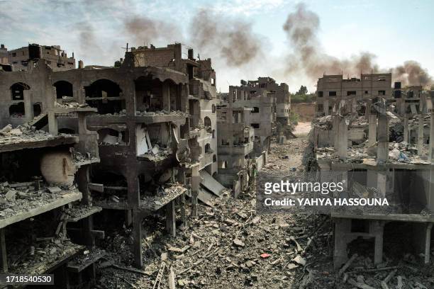This picture taken on October 11, 2023 shows an aerial view of buildings destroyed by Israeli air strikes in the Jabalia camp for Palestinian...