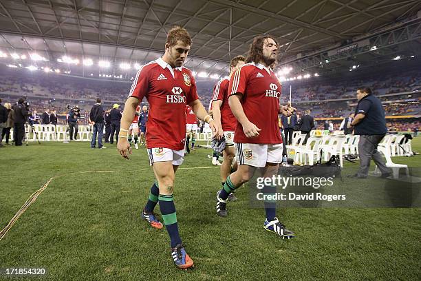 Leigh Halfpenny, the Lions fullback, who had a chance to win the match with a last minute penalty walks off the field with team mate Adam Jones after...