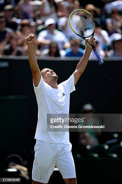 Mikhail Youzhny of Russia celebrates match point during his Gentlemen's Singles third round match against Viktor Troicki of Serbia on day six of the...