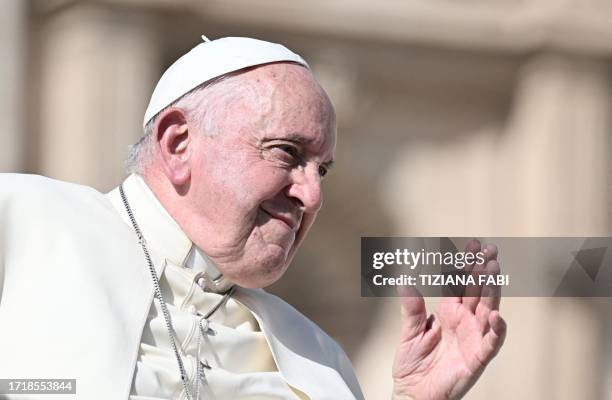 Pope Francis waves as he leaves at the end of his weekly general audience on St.Peter's square on October 11, 2023.